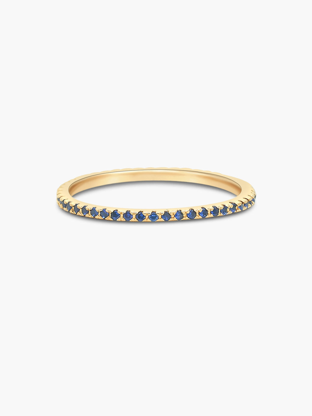 gold eternity band with blue CZ