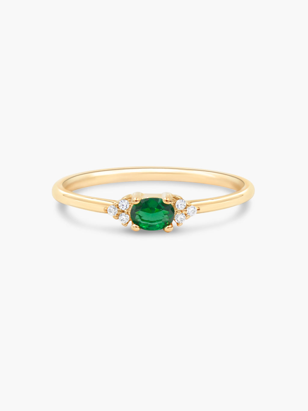 gold oval ring with green stones