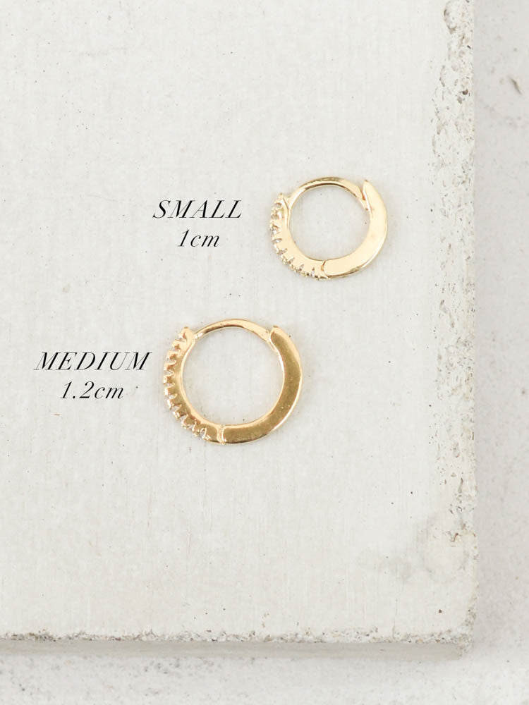 gold mini hoop huggie earrings by the faint hearted jewelry 